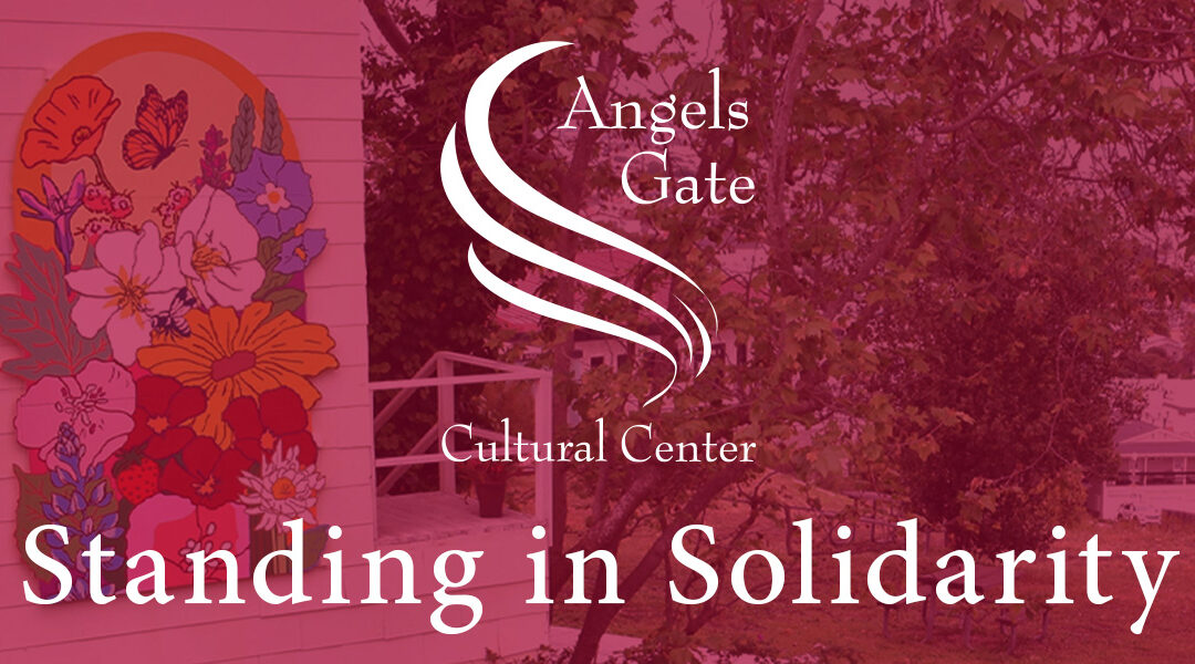 Photo of AGCC campus, mural of butterfly and flowers by Teen Mural Club on the side of a building overlooking LA Harbor. Photo overlayed with burgundy tint and white AGCC logo and text: Standing in Solidarity